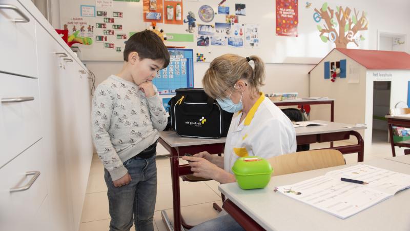 Foto verpleegkundige en kindje met diabetes op school