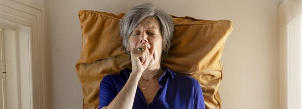 Geeuwende vrouw in bed